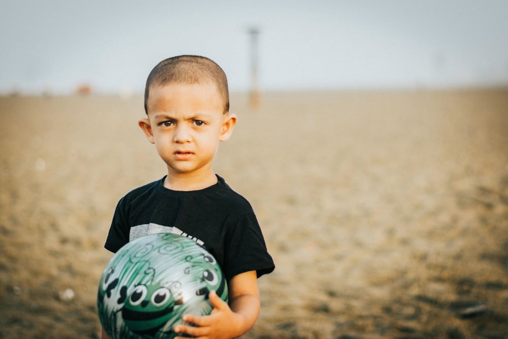 Boy holding a ball - Tahlia Riaz for Pexels.com